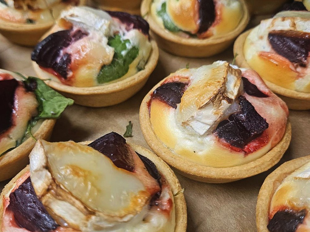 An image showing goats cheese and beetroot mini quiches